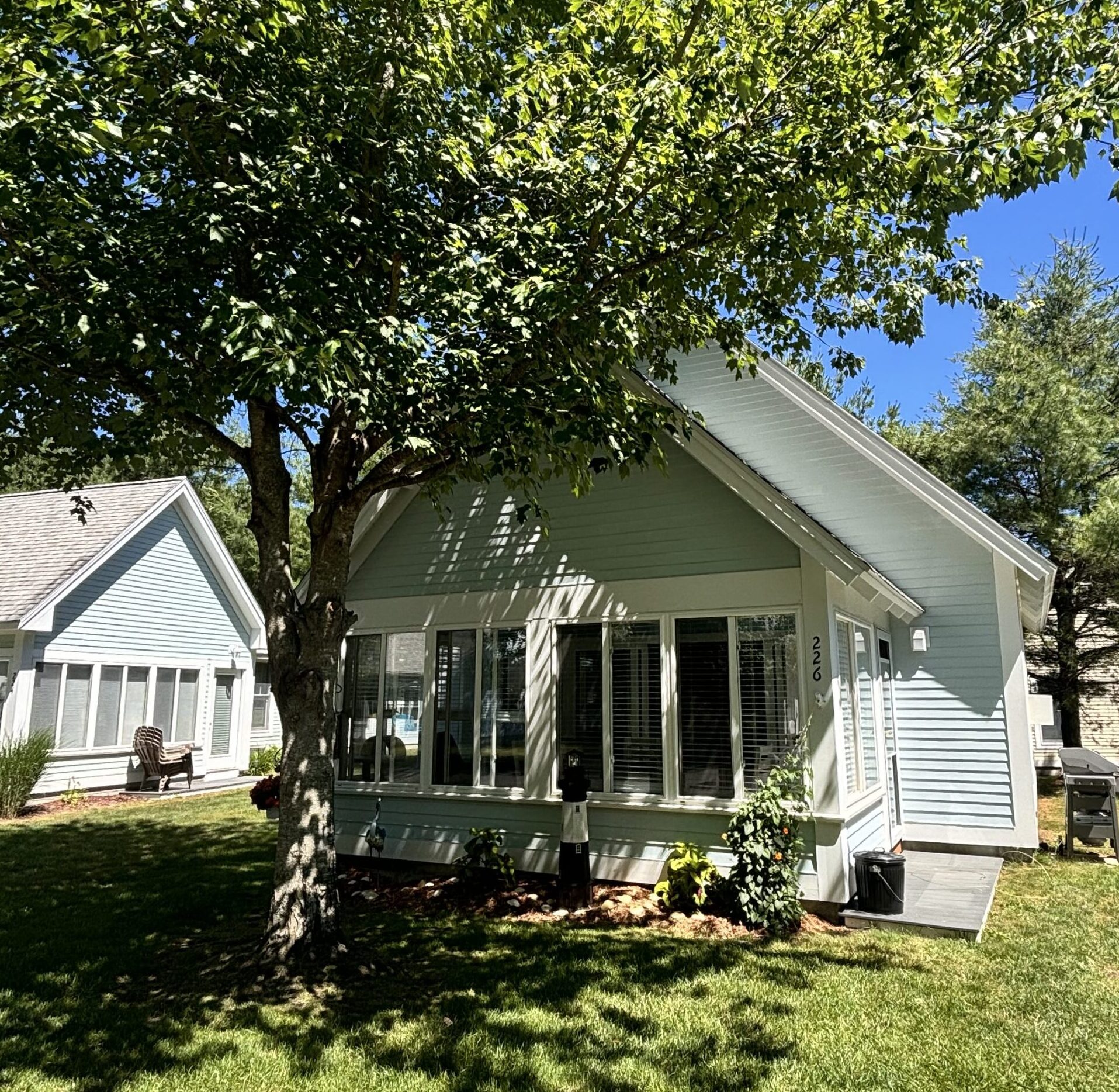 exterior of a Summer village cottage facing the screened in porch