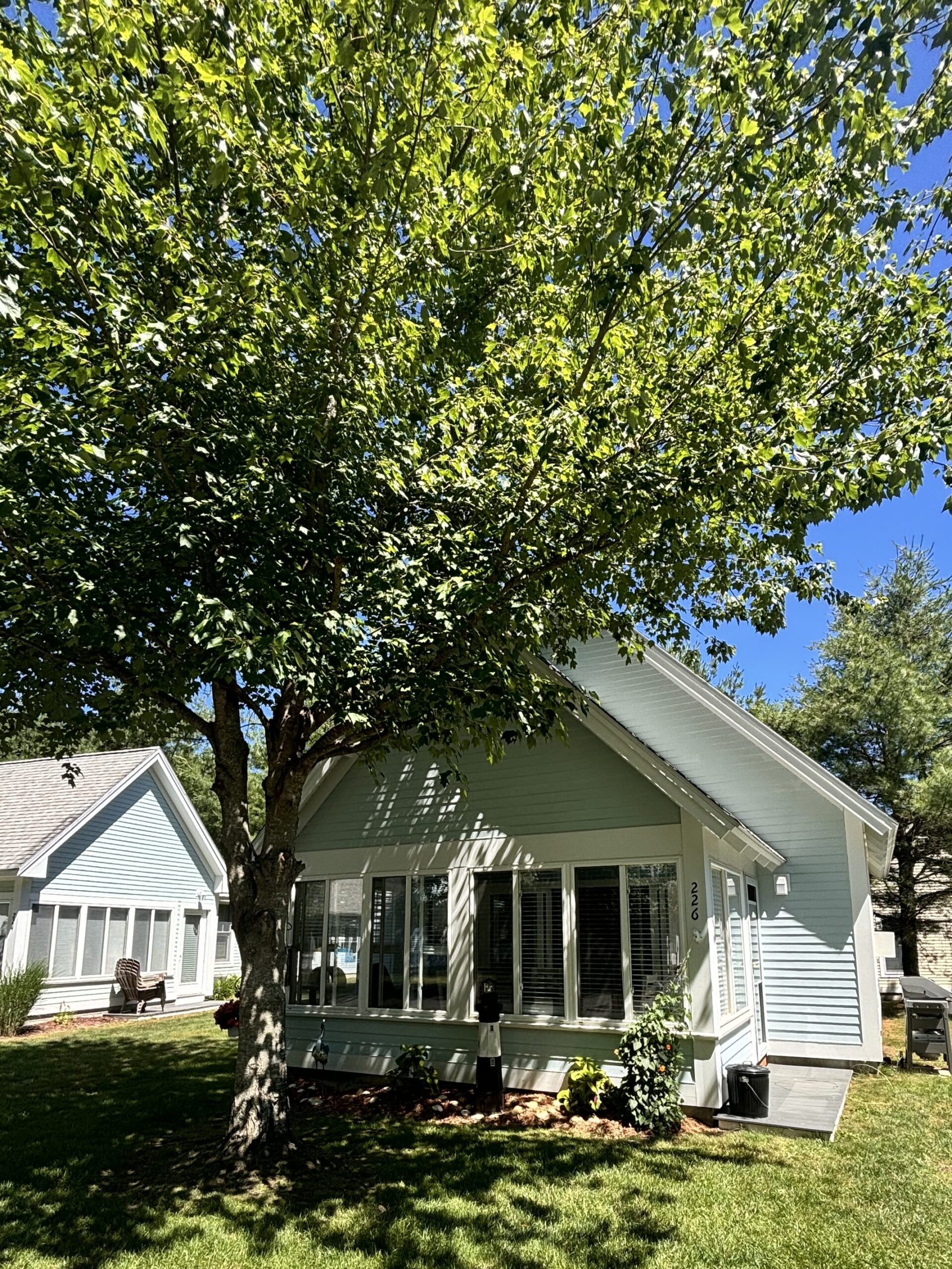 exterior of a Summer village cottage facing the screened in porch